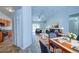 Bright living room features vaulted ceilings, tile flooring, and access to the kitchen and outdoor patio at 637 Twin Lake Ave, Deltona, FL 32738