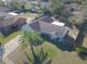 Aerial view showing a single Gathering home with a detached garage and palm tree at 824 Mentmore Cir, Deltona, FL 32738