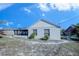 House exterior view, showcasing a screened patio and fenced yard at 824 Mentmore Cir, Deltona, FL 32738