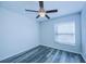 Bedroom with window, ceiling fan and wood-look floors at 824 Mentmore Cir, Deltona, FL 32738