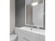 Modern bathroom with white vanity and gray tile at 8348 Lindahl Aly, Orlando, FL 32827