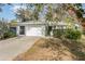 One-story house with a white garage door and landscaping at 11 Ginger Cir, Leesburg, FL 34748