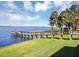 Serene lakeside property with a long dock, ideal for fishing and enjoying water activities at 1112 Hull Island Dr, Oakland, FL 34787