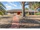 Front entrance of a ranch-style house with red door and a walkway at 1265 Lake Francis Dr, Apopka, FL 32712