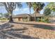 Ranch style home with mature landscaping and red front door at 1265 Lake Francis Dr, Apopka, FL 32712