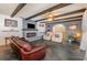 Living area featuring a fireplace, exposed beams, and stylish furniture at 1265 Lake Francis Dr, Apopka, FL 32712