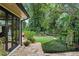 Landscaped backyard with stone patio and lush greenery at 1426 Nottingham St, Orlando, FL 32803