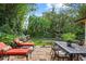 Relaxing stone patio with seating, dining area, lush landscaping, and a putting green at 1426 Nottingham St, Orlando, FL 32803
