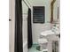 Clean bathroom with white tile, pedestal sink, and a classic vibe at 1426 Nottingham St, Orlando, FL 32803