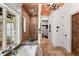Luxurious bathroom featuring a walk-in shower, soaking tub, and ornate carved doors at 1426 Nottingham St, Orlando, FL 32803