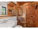 Bathroom featuring bronze tile, glass shower door, and decorative mirror at 1426 Nottingham St, Orlando, FL 32803