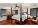 Elegant bedroom with hardwood floors, four-poster bed, and plantation shutters at 1426 Nottingham St, Orlando, FL 32803