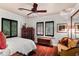 Bright bedroom with hardwood floors, a ceiling fan, and plantation shutters at 1426 Nottingham St, Orlando, FL 32803