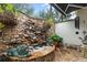 Private courtyard with a stone fountain, lush landscaping and stonework at 1426 Nottingham St, Orlando, FL 32803