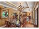 Formal dining room with glass-top table, chandelier, and hardwood floors at 1426 Nottingham St, Orlando, FL 32803