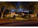 Charming home exterior with manicured lawn, mature trees, and inviting curb appeal illuminated at twilight at 1426 Nottingham St, Orlando, FL 32803