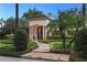 Elegant home with stone pathway, lush landscaping, and a captivating entryway at 1426 Nottingham St, Orlando, FL 32803