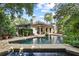 Stunning home exterior with pool, lush landscaping, and expansive patio at 1426 Nottingham St, Orlando, FL 32803