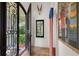 Inviting foyer with decorative iron door, tile flooring, and unique artwork create a grand entry at 1426 Nottingham St, Orlando, FL 32803