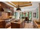 Gourmet kitchen features dark wood cabinetry, granite countertops, stainless steel appliances, and adjacent breakfast nook at 1426 Nottingham St, Orlando, FL 32803