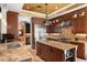 Chef's kitchen boasts dark wood cabinetry, stainless steel appliances, granite countertops, and ample storage space at 1426 Nottingham St, Orlando, FL 32803
