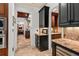 Kitchenette area with dark wood cabinets, granite countertops, and an archway leading to other rooms at 1426 Nottingham St, Orlando, FL 32803