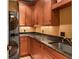 Laundry room with wood cabinets, granite countertops and a utility sink at 1426 Nottingham St, Orlando, FL 32803