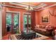 Relaxing living room featuring a leather sofa, coffee table, and French doors opening to a patio at 1426 Nottingham St, Orlando, FL 32803