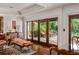 Living room showcasing hardwood floors, a cabinet, and a view of the outdoor patio at 1426 Nottingham St, Orlando, FL 32803