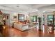 Elegant living room featuring hardwood floors, a large mirror, and doors to the patio at 1426 Nottingham St, Orlando, FL 32803