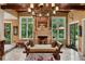 Living area with a fireplace, large windows, and wooden beams at 1426 Nottingham St, Orlando, FL 32803