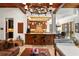 Spacious living room with wood-beamed ceiling, bar seating, and views of the kitchen and dining area at 1426 Nottingham St, Orlando, FL 32803
