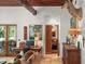 Inviting living room featuring wood beamed ceilings, unique doors, and an array of decorative art pieces at 1426 Nottingham St, Orlando, FL 32803
