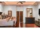 Main bedroom featuring hardwood floors, decorative art pieces, and ornate wood doors at 1426 Nottingham St, Orlando, FL 32803