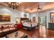 Spacious main bedroom with a chandelier, rich hardwood floors, and access to the en-suite bathroom at 1426 Nottingham St, Orlando, FL 32803