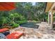 Inviting pool area with flagstone patio, lush landscaping, and comfortable lounge chairs at 1426 Nottingham St, Orlando, FL 32803