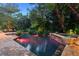 Relaxing pool and spa area with stone patio and lush landscaping at 1426 Nottingham St, Orlando, FL 32803