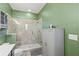 Clean bathroom with walk-in shower and green walls at 15322 Murcott Blossom Blvd, Winter Garden, FL 34787