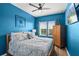 Bedroom with ceiling fan, wood floor, and blue walls at 15322 Murcott Blossom Blvd, Winter Garden, FL 34787