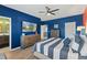 Bright bedroom with blue walls, large TV and comfortable bed at 15322 Murcott Blossom Blvd, Winter Garden, FL 34787