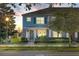 Two-story townhome with light blue exterior, landscaping, and front porch at 15322 Murcott Blossom Blvd, Winter Garden, FL 34787