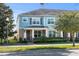 Two-story townhome with light blue exterior, landscaping, and front porch at 15322 Murcott Blossom Blvd, Winter Garden, FL 34787