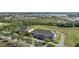 A stunning aerial view captures townhomes nestled beside a tranquil lake and lush greenery for relaxed community living at 15322 Murcott Blossom Blvd, Winter Garden, FL 34787
