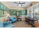 Home office with two teal armchairs and built-in shelving at 15322 Murcott Blossom Blvd, Winter Garden, FL 34787