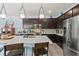 Modern kitchen with dark cabinetry, quartz countertops, and island at 15322 Murcott Blossom Blvd, Winter Garden, FL 34787