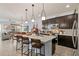 Modern kitchen with dark cabinetry, quartz countertops, and island at 15322 Murcott Blossom Blvd, Winter Garden, FL 34787