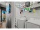 Bright laundry room with washer, dryer, and ample shelving at 15322 Murcott Blossom Blvd, Winter Garden, FL 34787