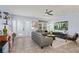 Open living area featuring gray sofas and a large TV at 15322 Murcott Blossom Blvd, Winter Garden, FL 34787