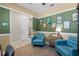 Inviting living room with two blue armchairs, unique decorations, and fresh flooring at 15322 Murcott Blossom Blvd, Winter Garden, FL 34787
