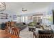 Bright living room with two gray sofas, wood accent table, and large TV at 15322 Murcott Blossom Blvd, Winter Garden, FL 34787